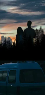 Silhouette of a couple at sunset with a van in the foreground.