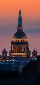 Majestic cathedral under a vibrant orange sunset sky.