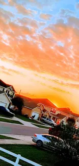 Vibrant sunset over a suburban neighborhood with colorful sky.