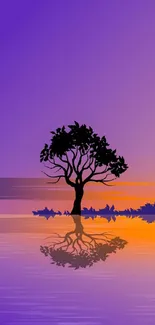 Lone tree reflecting in water during a purple and orange sunset scene.