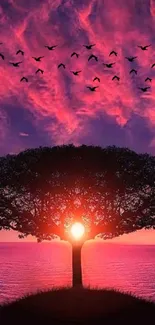 Majestic sunset tree with flying birds over calm waters.