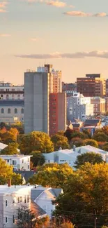 A vibrant cityscape at sunset with autumn trees and a warm color palette.