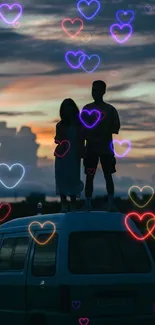 Silhouette of couple on van roof under sunset sky.