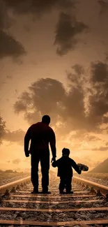 Silhouette of father and child walking on a railroad track at sunset.