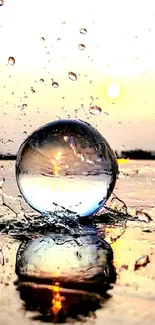 Crystal ball with sunset reflection and water splash, creating an artistic scene.