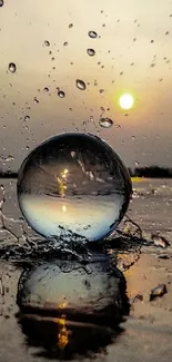 Sunset reflecting in water sphere with droplets.