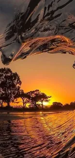 Stunning orange sunset seen through a crashing wave.