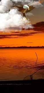 Silhouette by lake at sunset with eagle flying above.