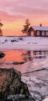 Serene winter lake at sunset with pink skies and a cozy cabin.