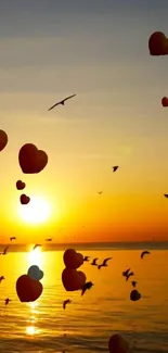 A serene sunset with hearts floating and birds flying over the ocean.