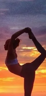 Yoga silhouette at sunset with vibrant colors.