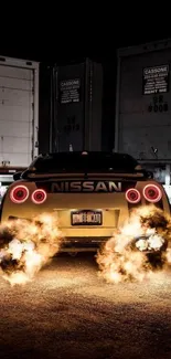 Nissan supercar emits flames in night industrial setting wallpaper.