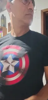 Person wearing superhero t-shirt in room.