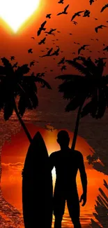 Silhouette of a surfer by palm trees against a vibrant orange sunset with birds flying.