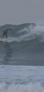 Surfer riding a large ocean wave at the beach.