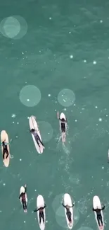 Aerial view of surfers on turquoise ocean.