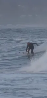 Surfer riding a wave in blue ocean wallpaper.