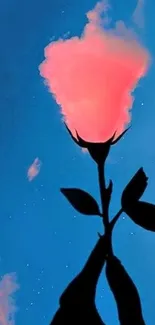 Silhouette of a hand holding a flower with a cloud-like bloom on a blue sky background.