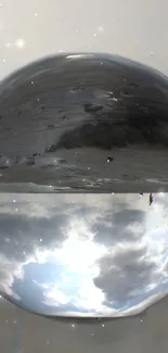 Reflective glass orb with surreal sky and gray tones.