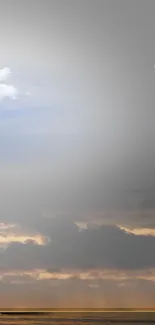 Surreal landscape with clouds and large moon over horizon.