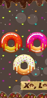 Colorful donut wallpaper with sprinkles and hearts on a brown background.