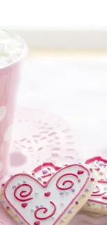 Heart-shaped cookies with pink icing on a soft pastel background.