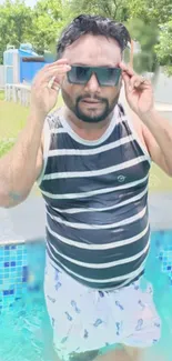 Man enjoying a sunny day in the pool wearing sunglasses.