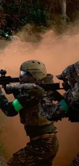 Soldiers in tactical gear amid dust and foliage in a forest.