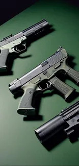 Tactical firearms displayed on dark green surface wallpaper.