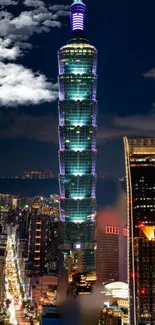 Illuminated Taipei 101 tower against night sky.