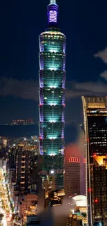 Taipei 101 at night with city lights and dark sky backdrop.