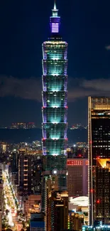 Night view of Taipei 101 with city lights and dark blue sky.