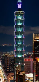 Taipei 101 skyscraper illuminated at night amidst city lights.