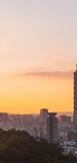 Taipei city skyline at sunset with vibrant peach sky and silhouette skyscrapers.