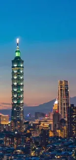 Scenic view of Taipei skyline illuminated at night under a blue sky.