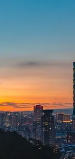 Taipei 101 at sunset with vibrant city skyline.