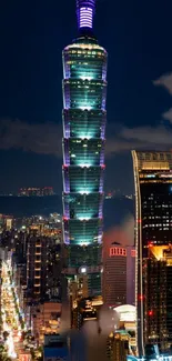 Taipei 101 tower and cityscape at night, featuring illuminated buildings.