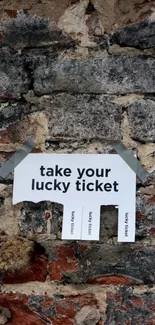 Mobile wallpaper with a lucky ticket sign on rustic brick wall.