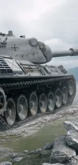 Wallpaper of a tank on rugged mountain terrain with a cloudy sky.