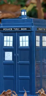 TARDIS model surrounded by autumn leaves.