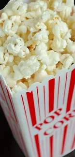 Box of popcorn with red and white stripes.