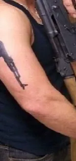 Artistic fusion of tattoo design and rifle imagery on arm.