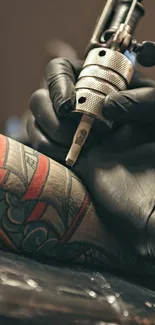 Close-up of a tattoo artist working on a colorful design.