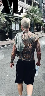 Tattooed individual walking on a city street, showcasing street style and modern art.