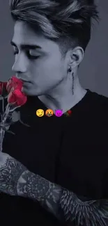 Tattooed man holding red rose in grayscale style with emojis.