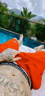 Relaxing poolside view with tattooed body and tropical scenery.