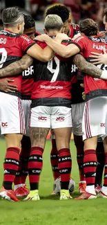 Soccer team in a huddle on the field, showing unity and teamwork.