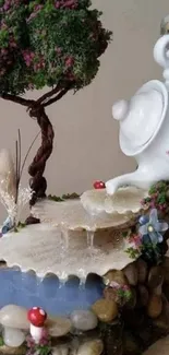 Miniature teapot garden with waterfall art scene.