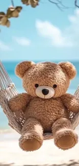 Teddy bear relaxes on a hammock by the beach.