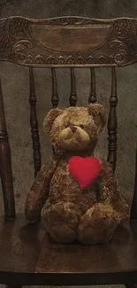 Teddy bear with red heart on a vintage wooden chair.